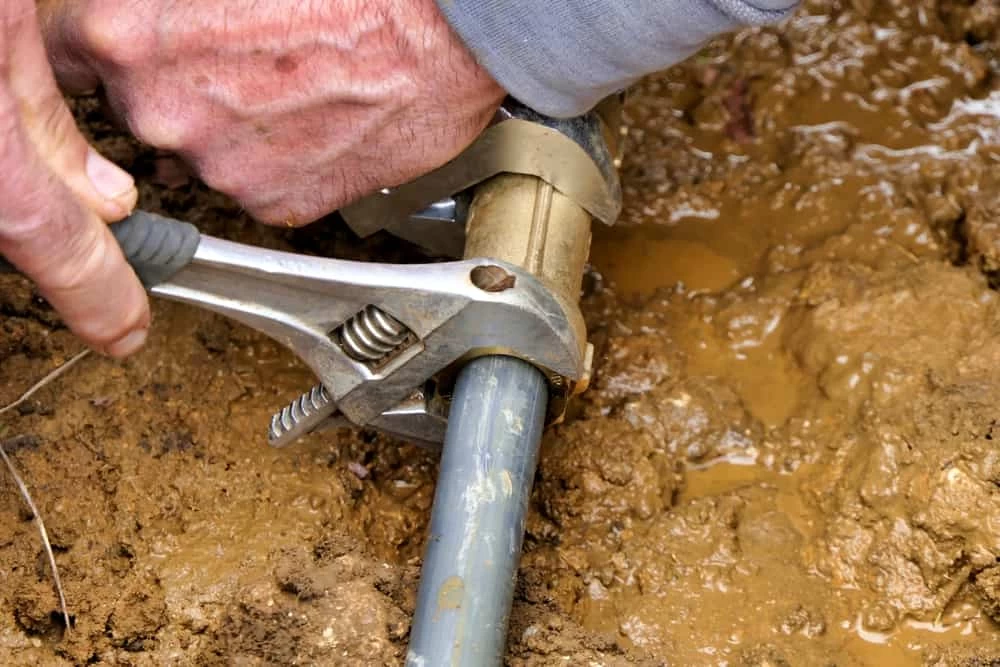 plumber repairing a broken pipe.