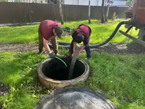 Technician pumping septic waste from a tank in Moscow, Russia during a scheduled sanitation service