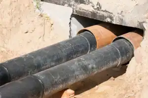 Old pipes undergoing rehabilitation with trenchless pipe lining installation to restore internal structure