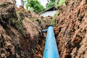 A water pipeline structure laid along a village path for local water supply and distribution