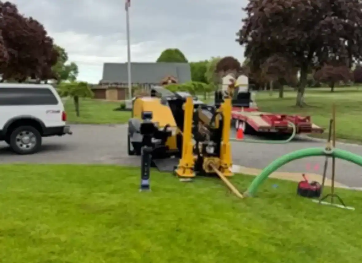 Trenchless plumbing equipment yard in Nassau County, NY, showing an organized outdoor space with various pipes, machinery, and specialized tools used for underground plumbing repairs without digging
